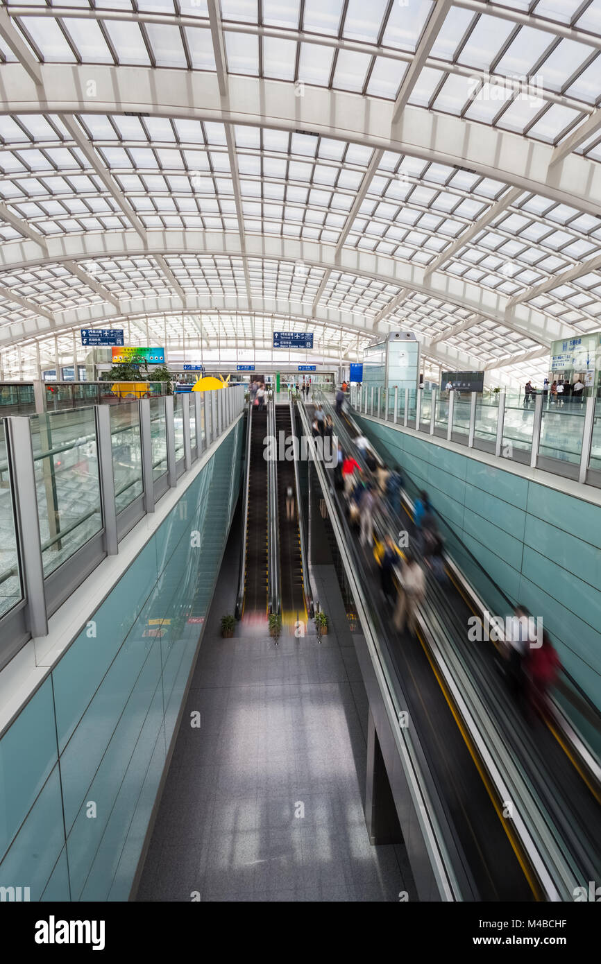 moving escalator within the modern airport hall Stock Photo