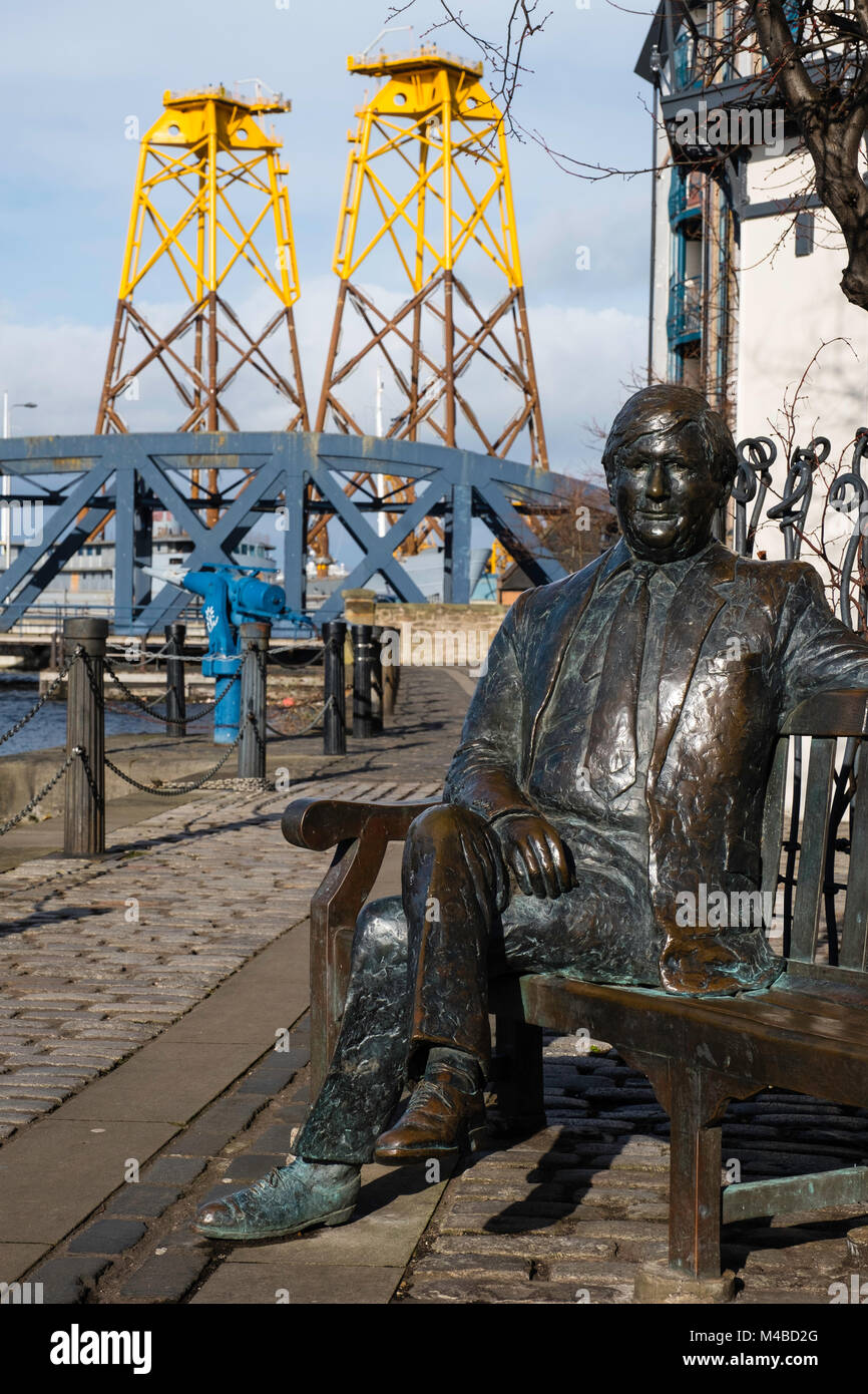 Statue of Sandy Irvine Robertson on bench on waterside at Leith in Edinburgh, Scotland, United Kingdom Stock Photo