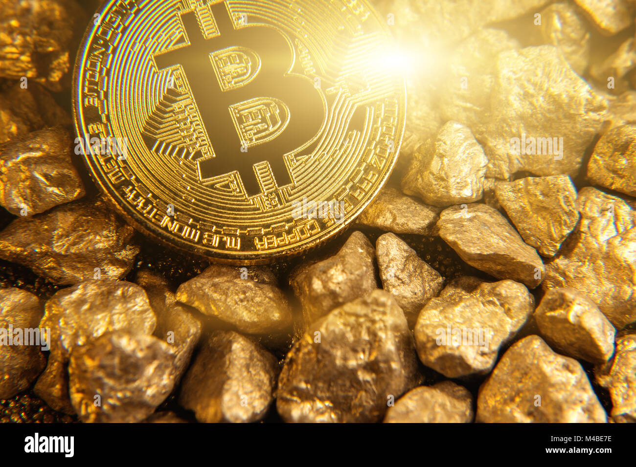 Golden shining bitcoin on mound of gold Stock Photo