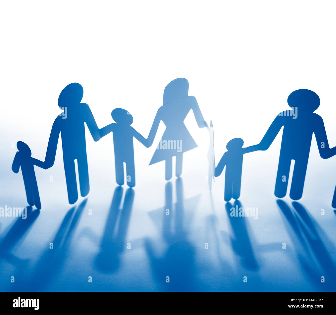 Family paper chain cutout holding hands Stock Photo - Alamy