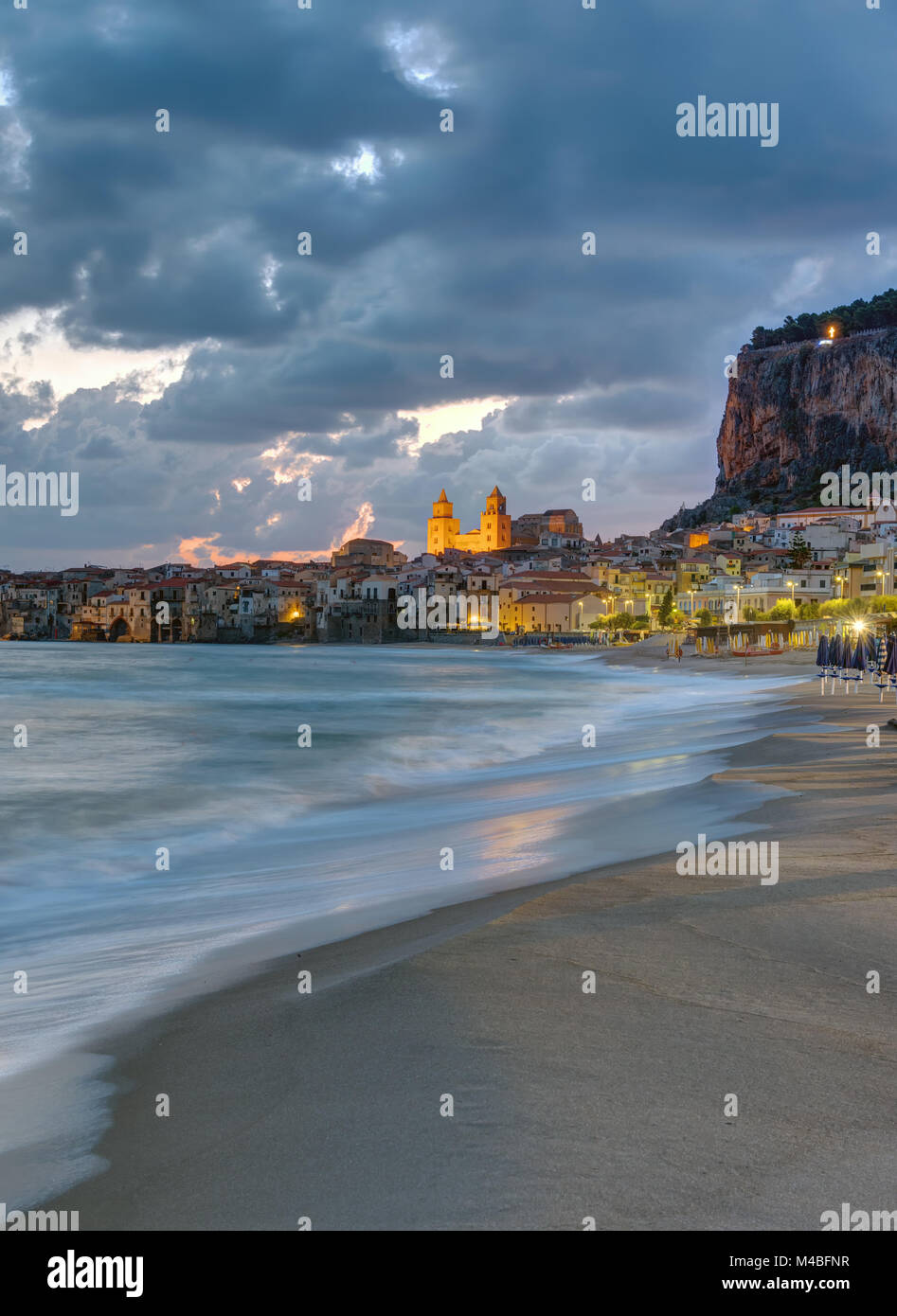 The beach of Cefalu in Sicily before sunrise Stock Photo