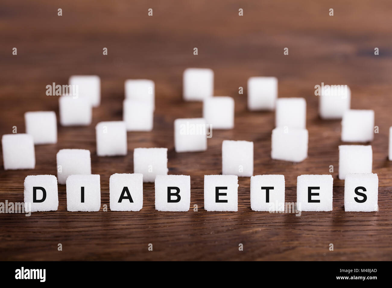 Diabetes Text On Sugar Cubes On Wooden Desk Stock Photo