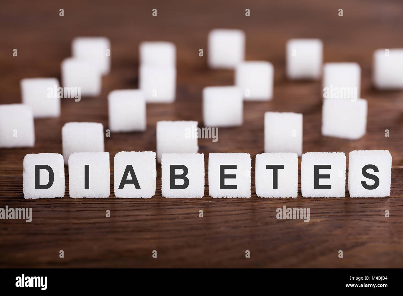 Diabetes Text On Sugar Cubes On Wooden Desk Stock Photo