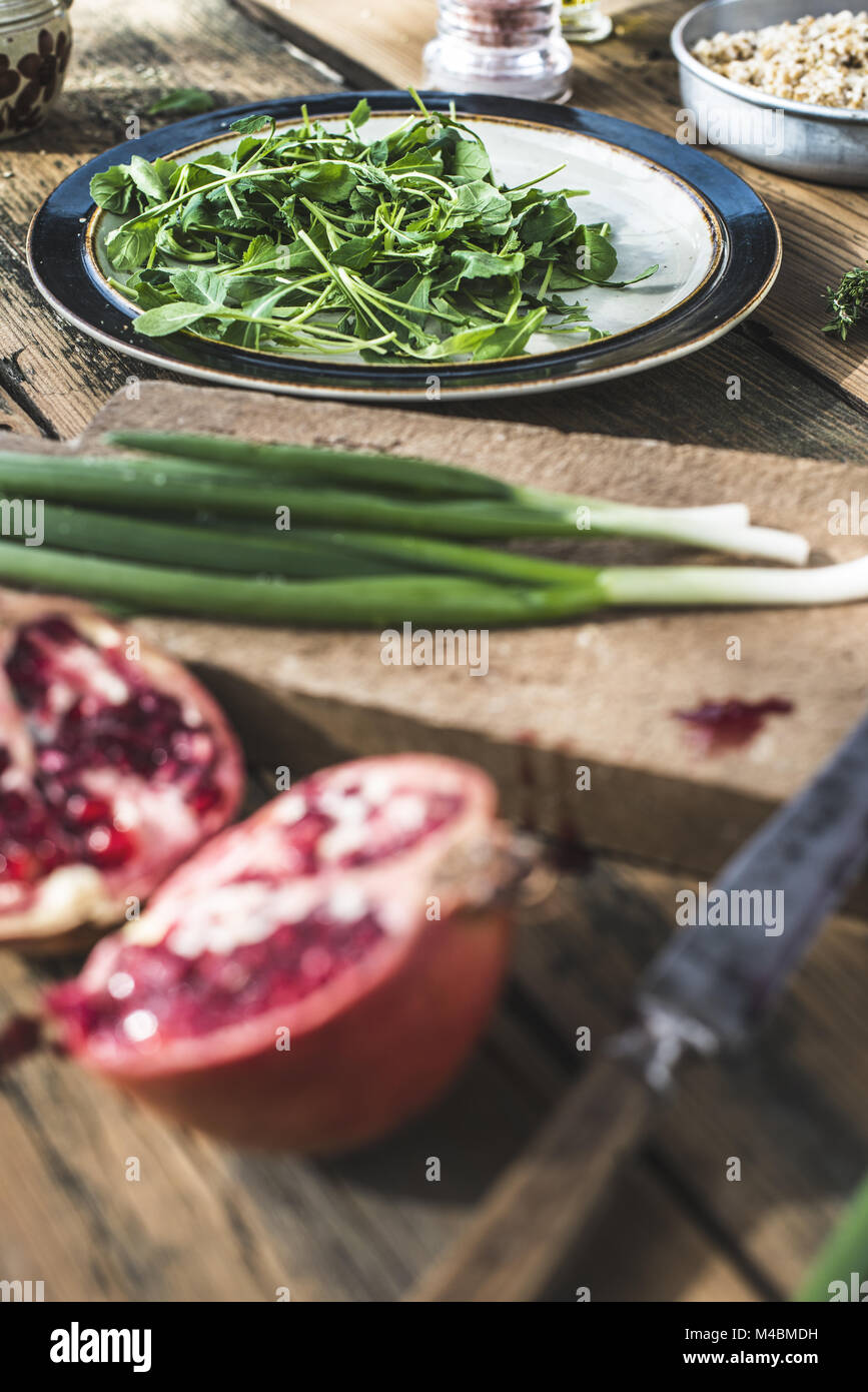 Green salad with pomegranate, manna croup, onion Stock Photo