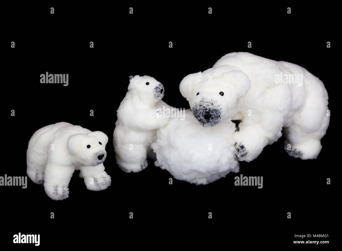 Polar bears family figurines playing with snowball Stock Photo
