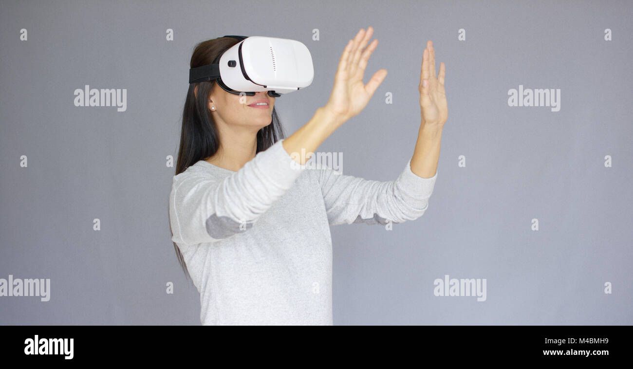 Adorable woman working with virtual reality glasses Stock Photo