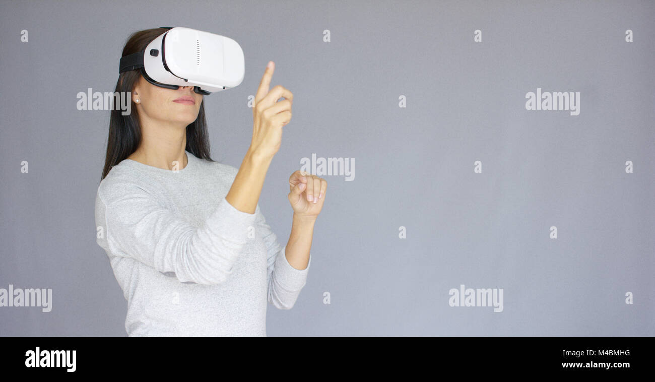 Adorable woman working with virtual reality glasses Stock Photo