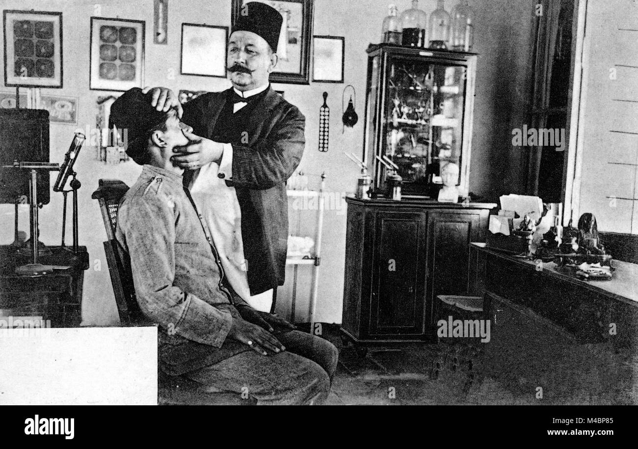 The Arab doctor Dr. Nikolaki examines the eyes of a patient,ca. 1910,Beirut,Lebanon Stock Photo