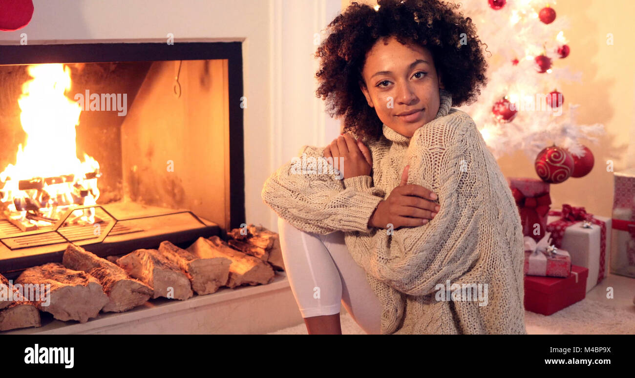 Woman smiles at camera while wearing sweater Stock Photo