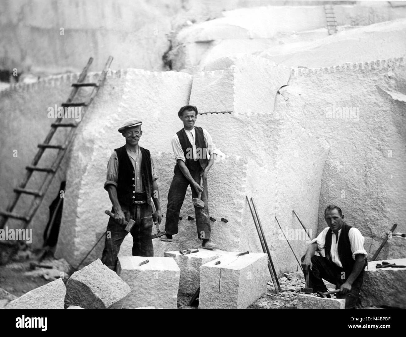 Three men working in the quarry,1920s,exact location unknown,Germany Stock Photo