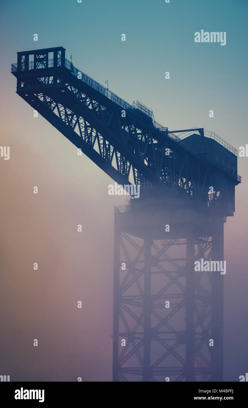 Industrial Crane At Sunrise In The Fog Stock Photo