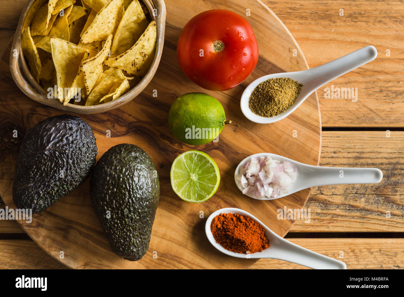Ingredients for Guacamole dip with avocado lime tomato and spices Stock Photo Alamy
