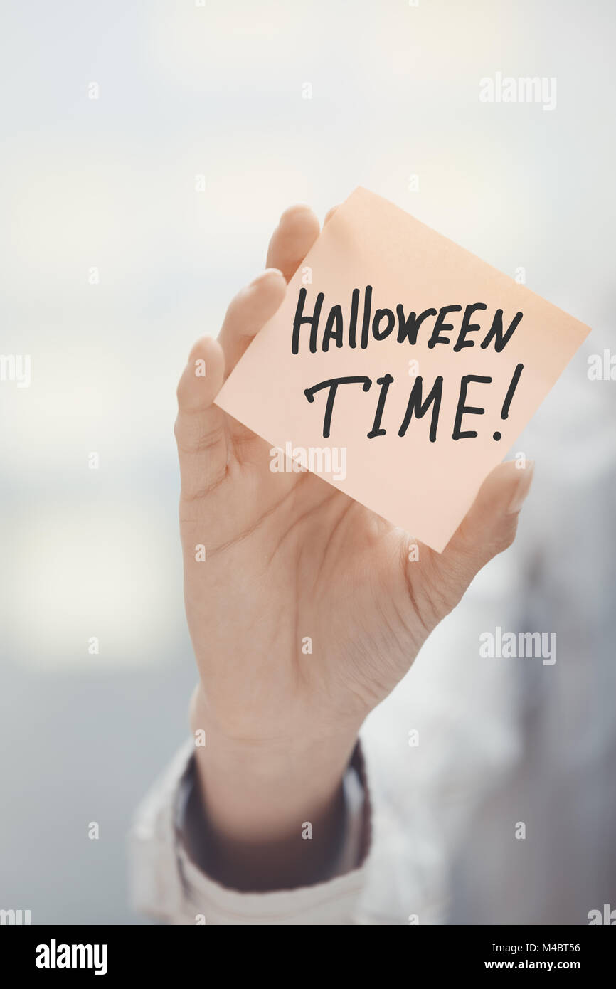 Woman holding agenda with Halloween time text Stock Photo