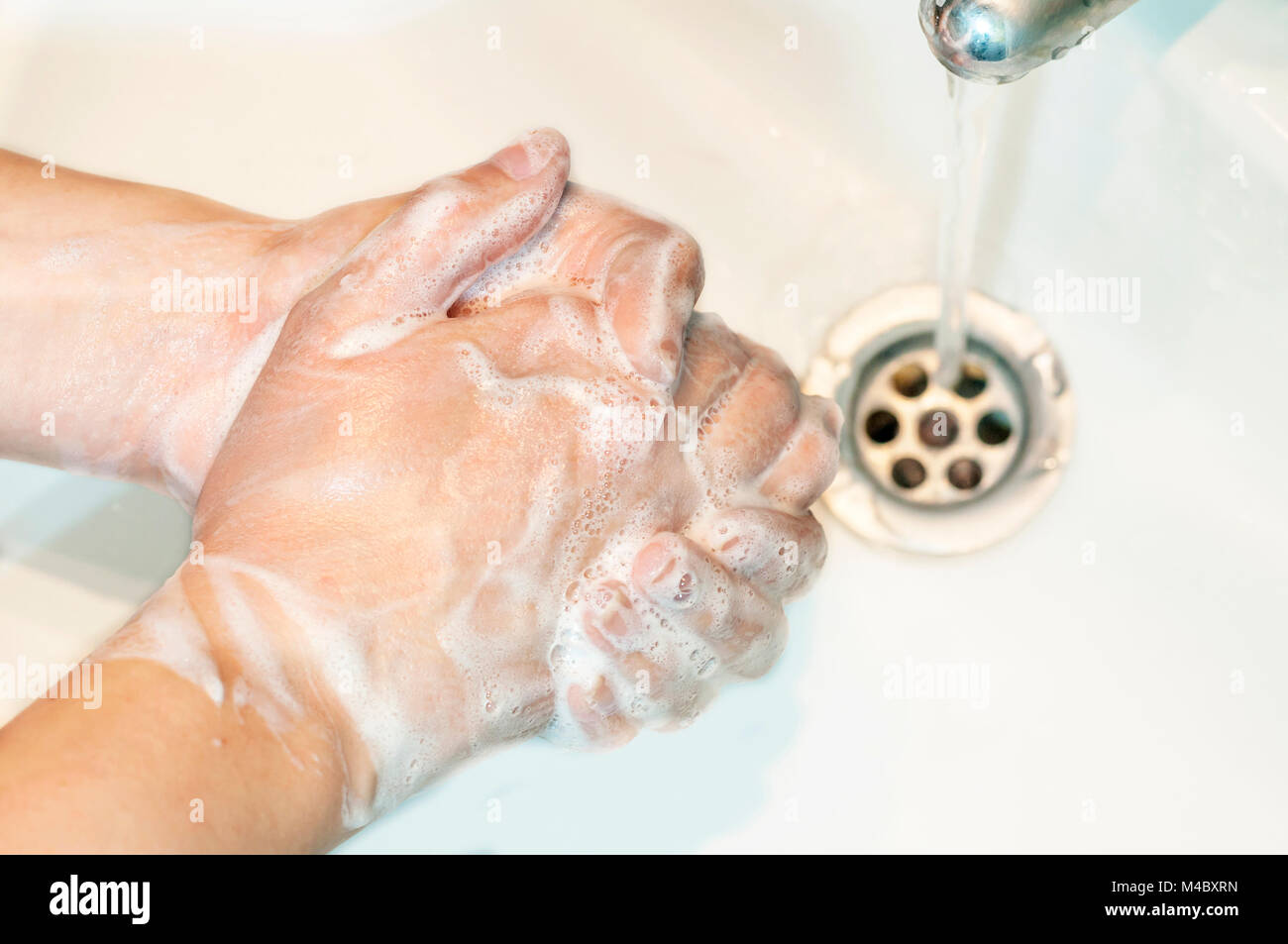 Washing of hands with soap under running water Stock Photo - Alamy