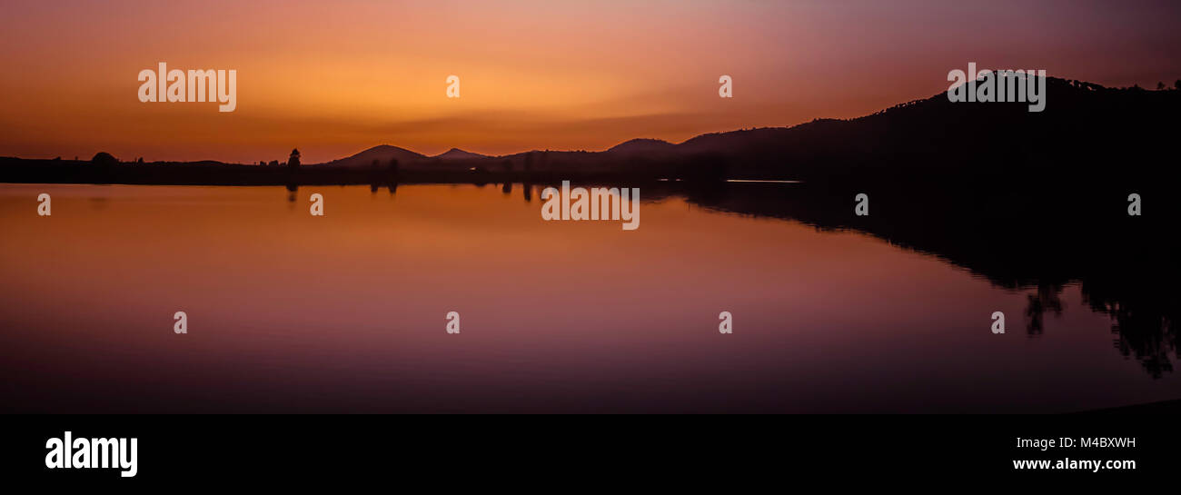 Silhouettes of mountains at sunset Stock Photo