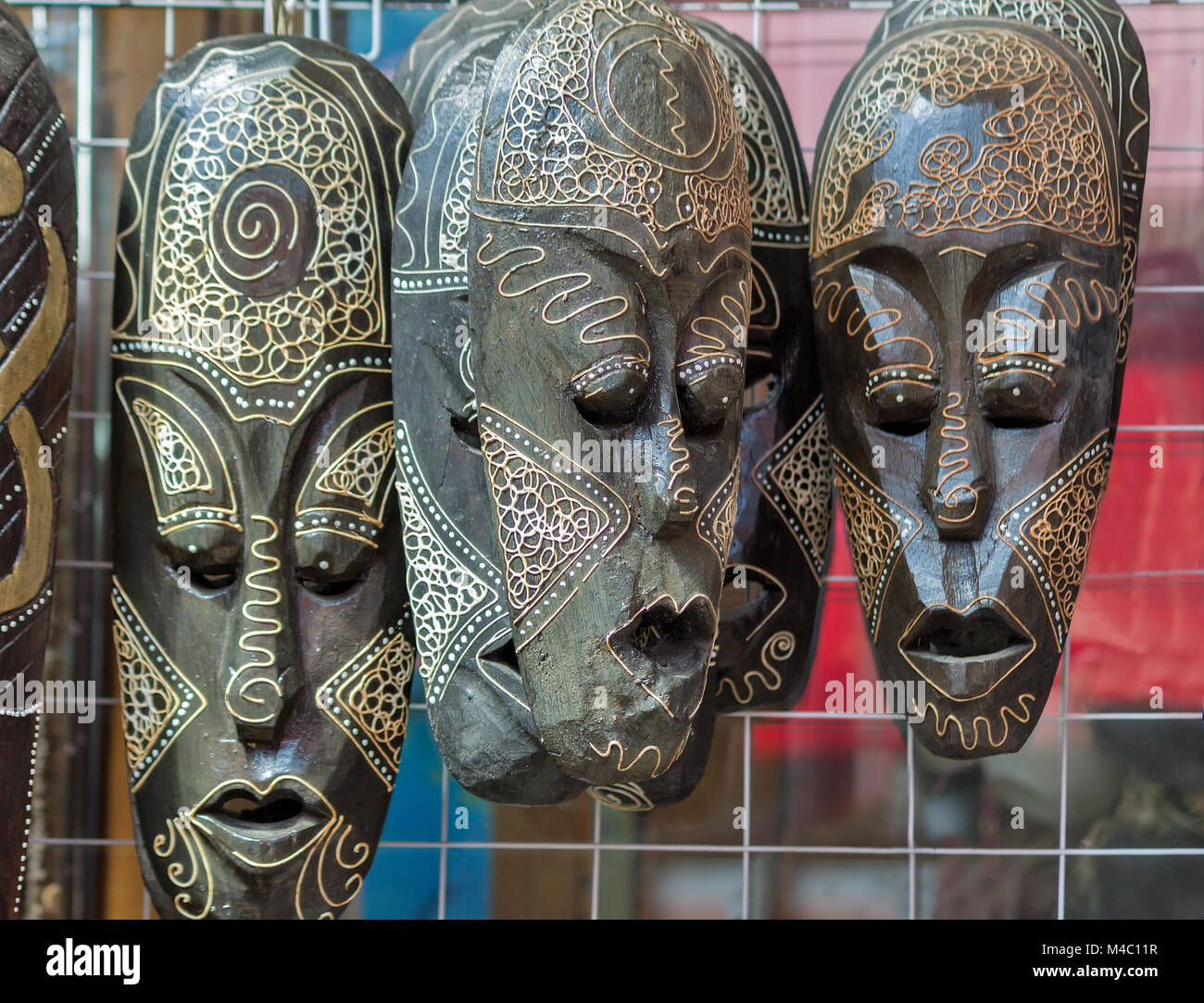 Souvenirs masks made of wood, symbolizing human emotions Stock Photo