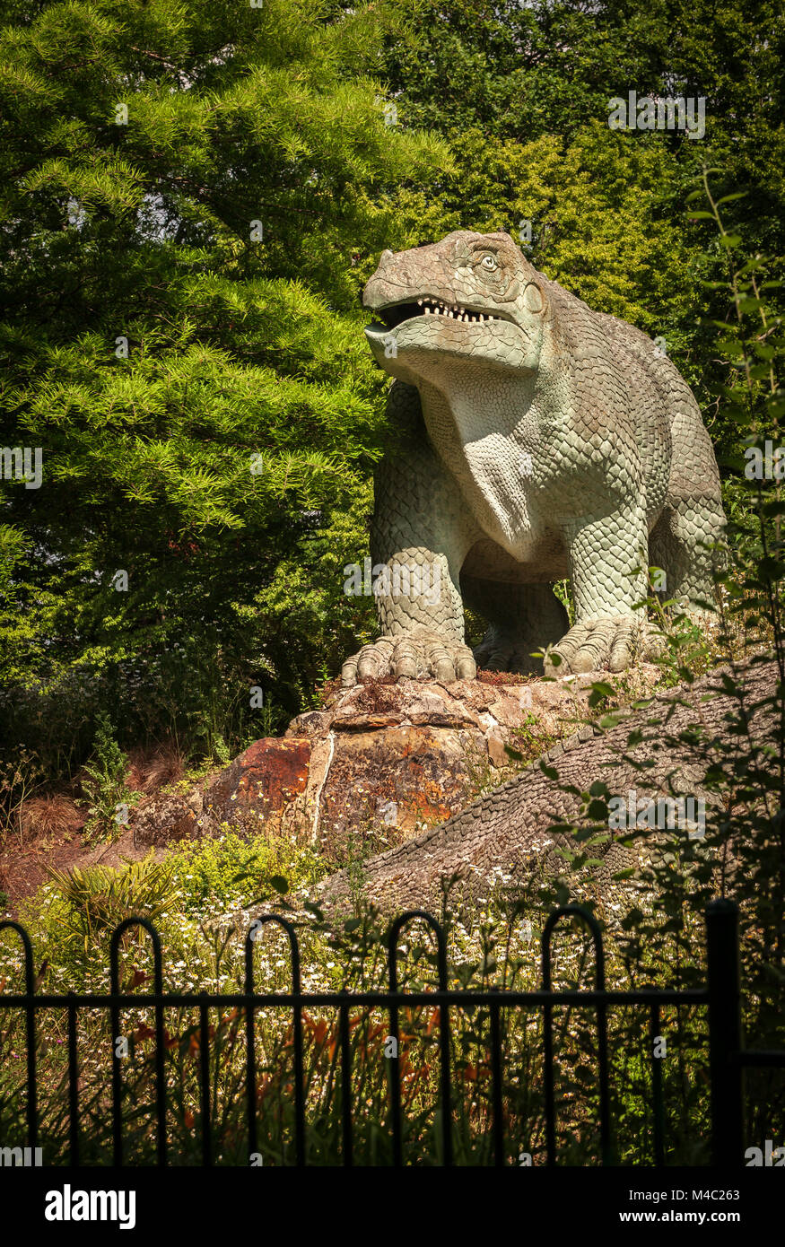 Dinosaur sculpture in a park Stock Photo Alamy