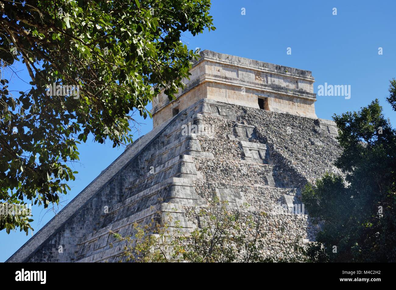 Temple at Chichen Itza with tree Stock Photo
