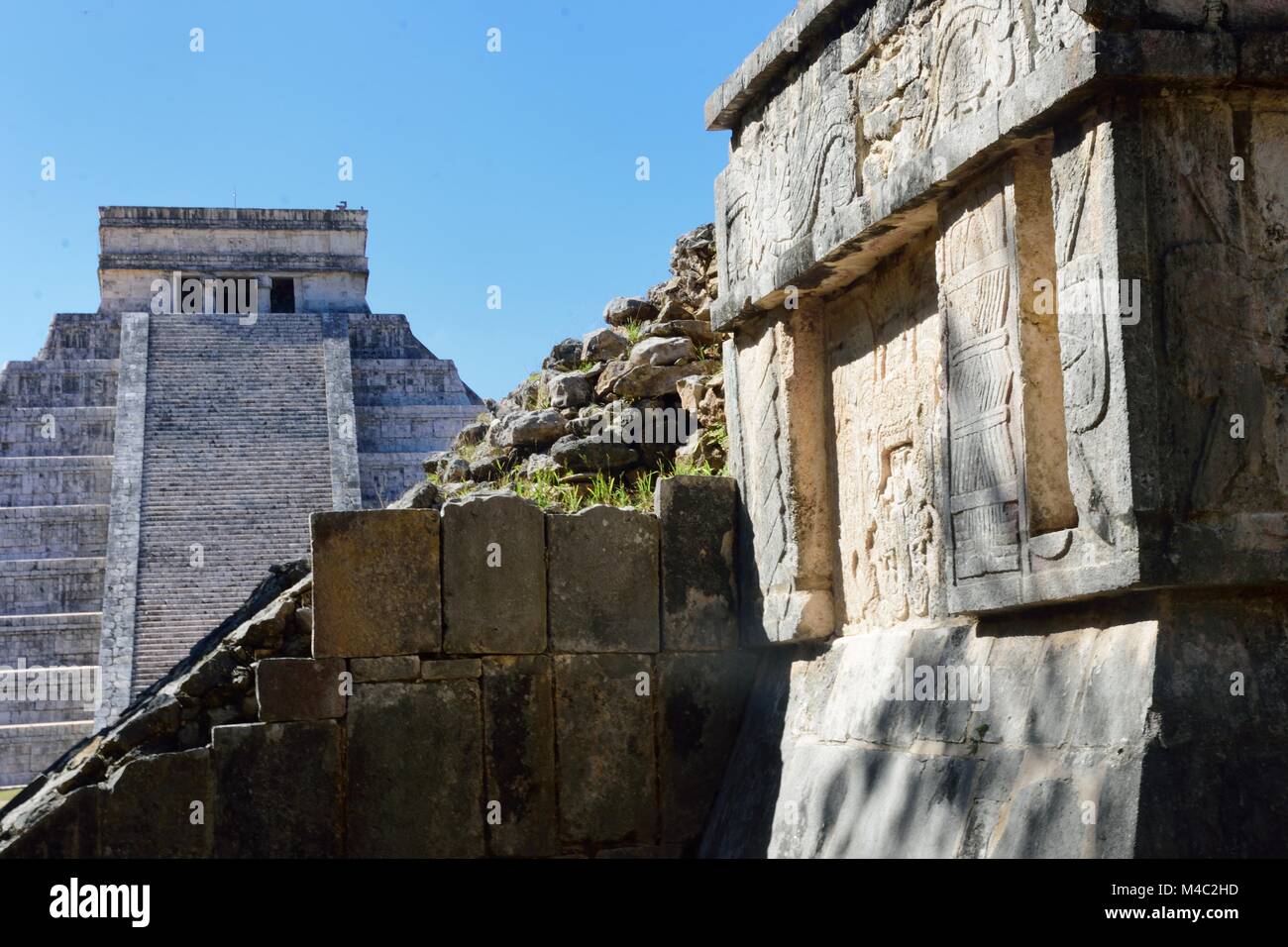 Chichen Itza wall with temple in background Stock Photo