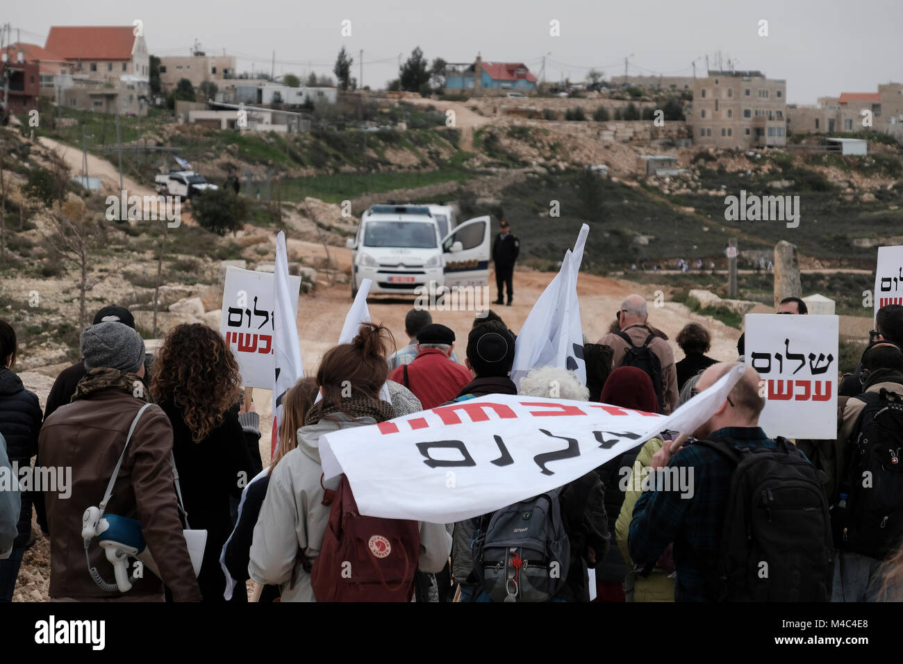 Nativ Ha'avot, Israel. 15th Feb, 2018. Members of the left-wing Peace Now movement taking part in a protest next to the illegal outpost of Nativ Ha'avot on following Israeli government attempts to postpone the removal of some of the houses in the outpost despite the Supreme Court ruling after accepting the petition of a group of Palestinians who argued the homes had been partially built illegally on their land. Credit: Eddie Gerald/Alamy Live News Stock Photo