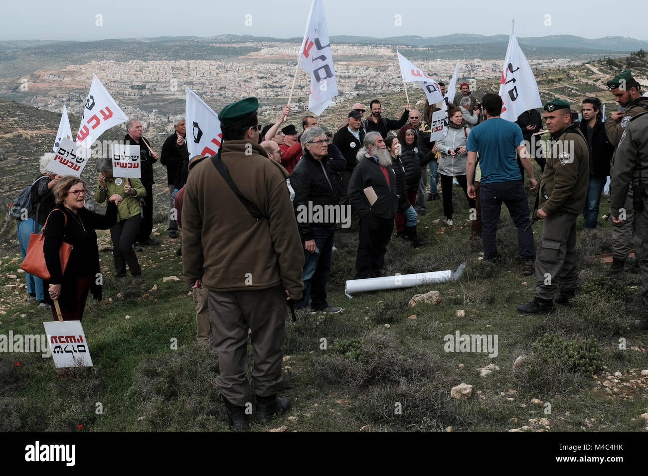 Nativ Ha'avot, Israel. 15th Feb, 2018. Members of the left-wing Peace Now movement taking part in a protest next to the illegal outpost of Nativ Ha'avot on following Israeli government attempts to postpone the removal of some of the houses in the outpost despite the Supreme Court ruling after accepting the petition of a group of Palestinians who argued the homes had been partially built illegally on their land. Credit: Eddie Gerald/Alamy Live News Stock Photo