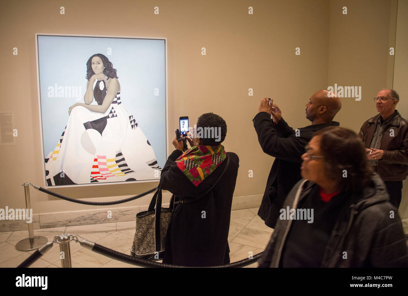 Washington, USA. 14th Feb, 2018. Visitors waited in line to view the new portrait of former First Lady Michelle Obama, at the National Portrait Gallery, Smithsonian Institution, Washington, DC. The painting, by Amy Sherald, was unveiled February 12, 2018. Credit: Tim Brown/Alamy Live News Stock Photo