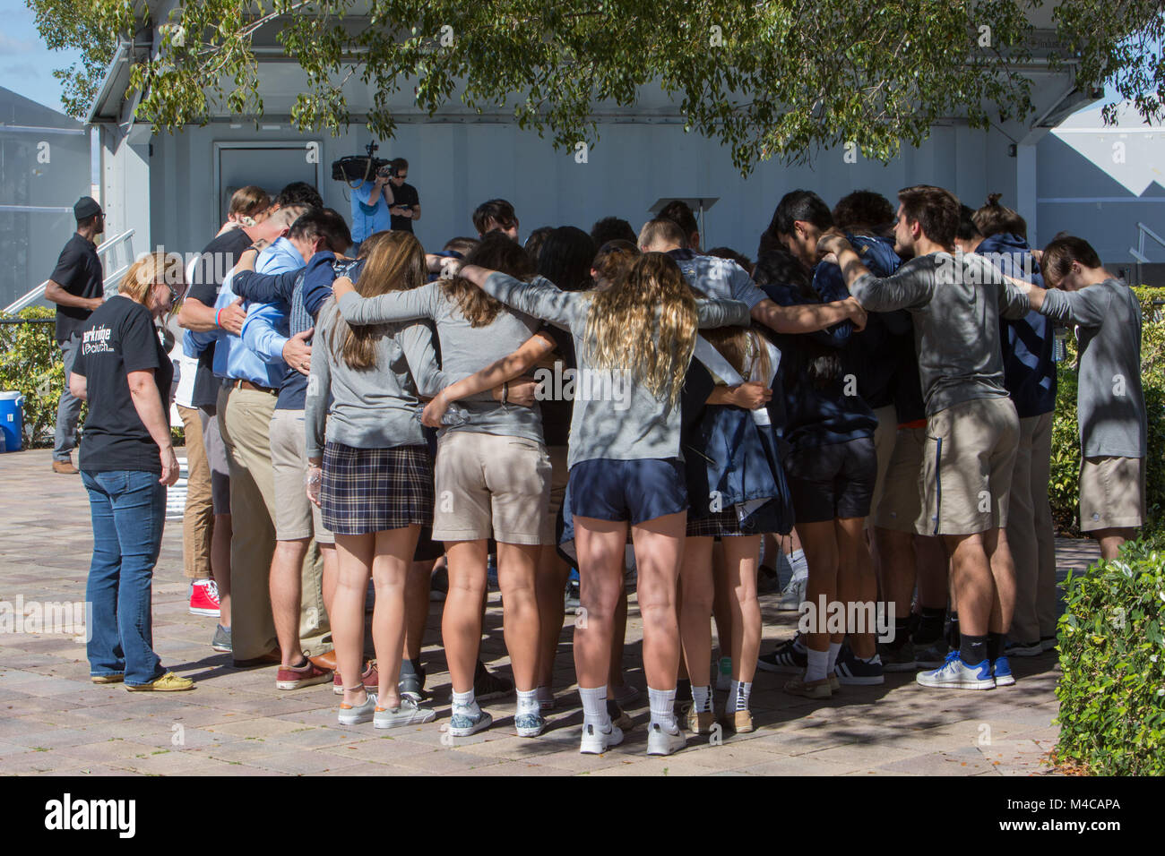Parkland, USA. 15th Feb, 2018. Community members share an emotional moment during a daytime prayer vigil at Parkridge Church in Parkland, Florida, the United States, on Feb. 15, 2018. A total of 17 people were killed and over a dozen others were wounded after a 19-year-old gunman opened fire Wednesday at the high school, authorities said. Credit: Monica McGivern/Xinhua/Alamy Live News Stock Photo