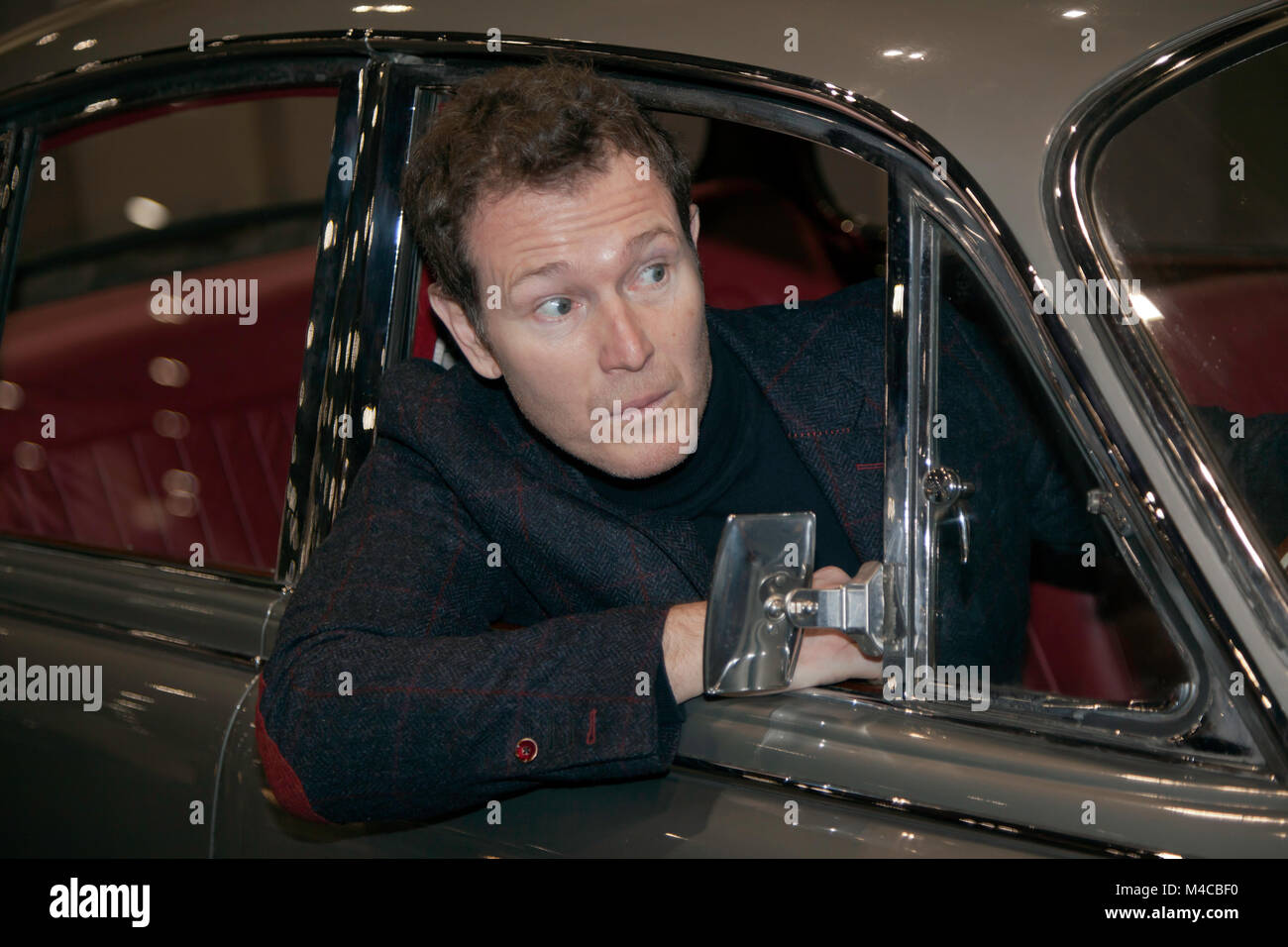 . Nick Moran from Lock, Stock and two Smoking Barrels poses in a Jaguar MkII 3.4, on the Get Away Cars Display at the 2018 London Classic Car Show Stock Photo