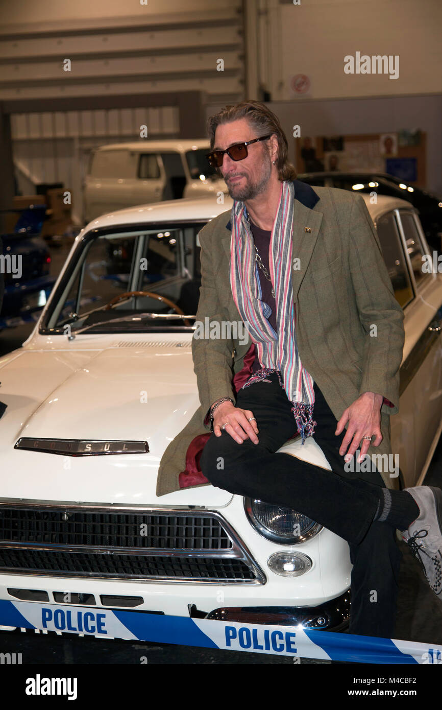 Nick Reynolds poses with his father's Lotus Cortina from the Great Train Robery, on the Getaway Cars Display, at the 2018 London Classic Car Show Stock Photo