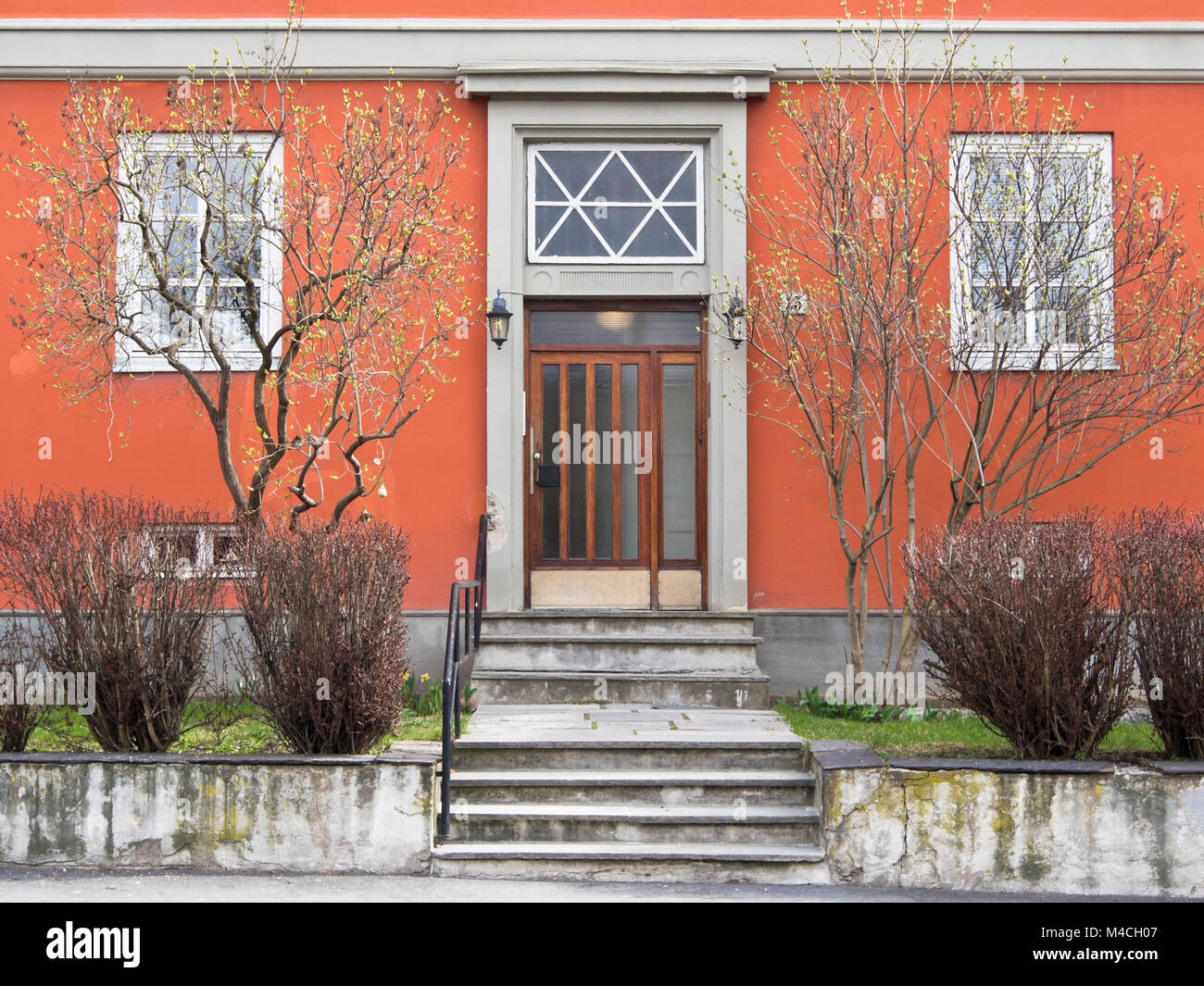 Symmetrical entrance facade with small front garden in an apartment block in the district Bislett in Oslo Norway Stock Photo