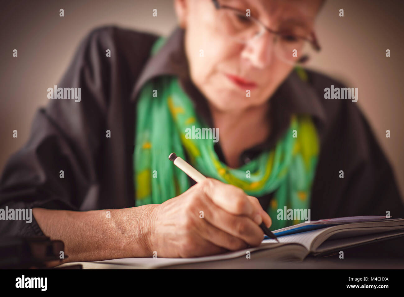 Writing an appointment in notebook Stock Photo