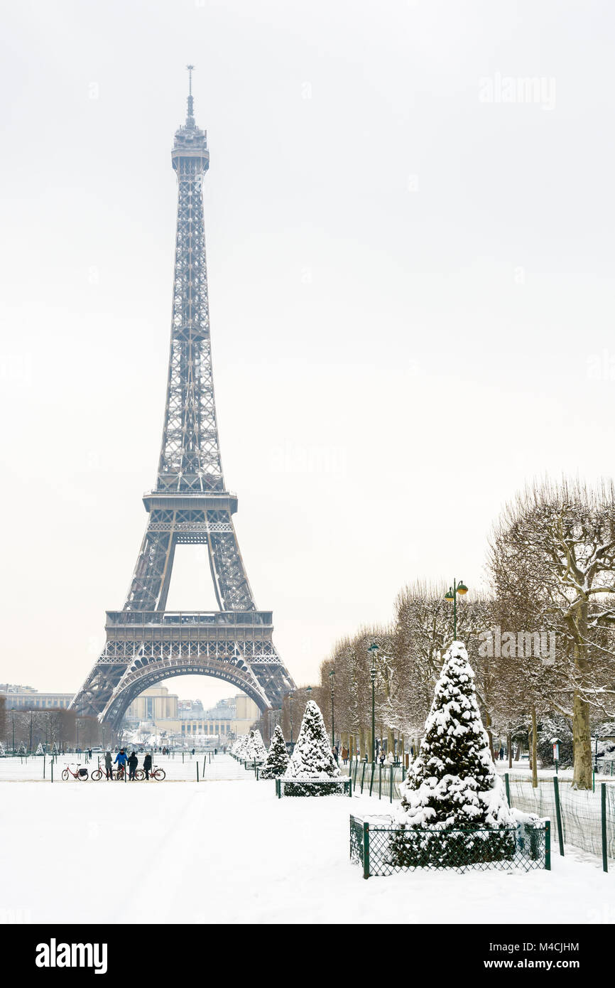 Winter in Paris in the snow. The Eiffel tower seen from the Champ de