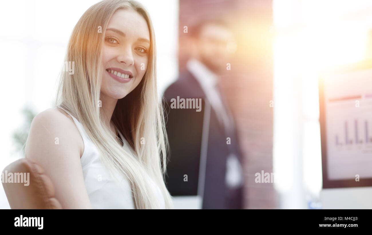 young business woman sitting at a desk in the office Stock Photo - Alamy