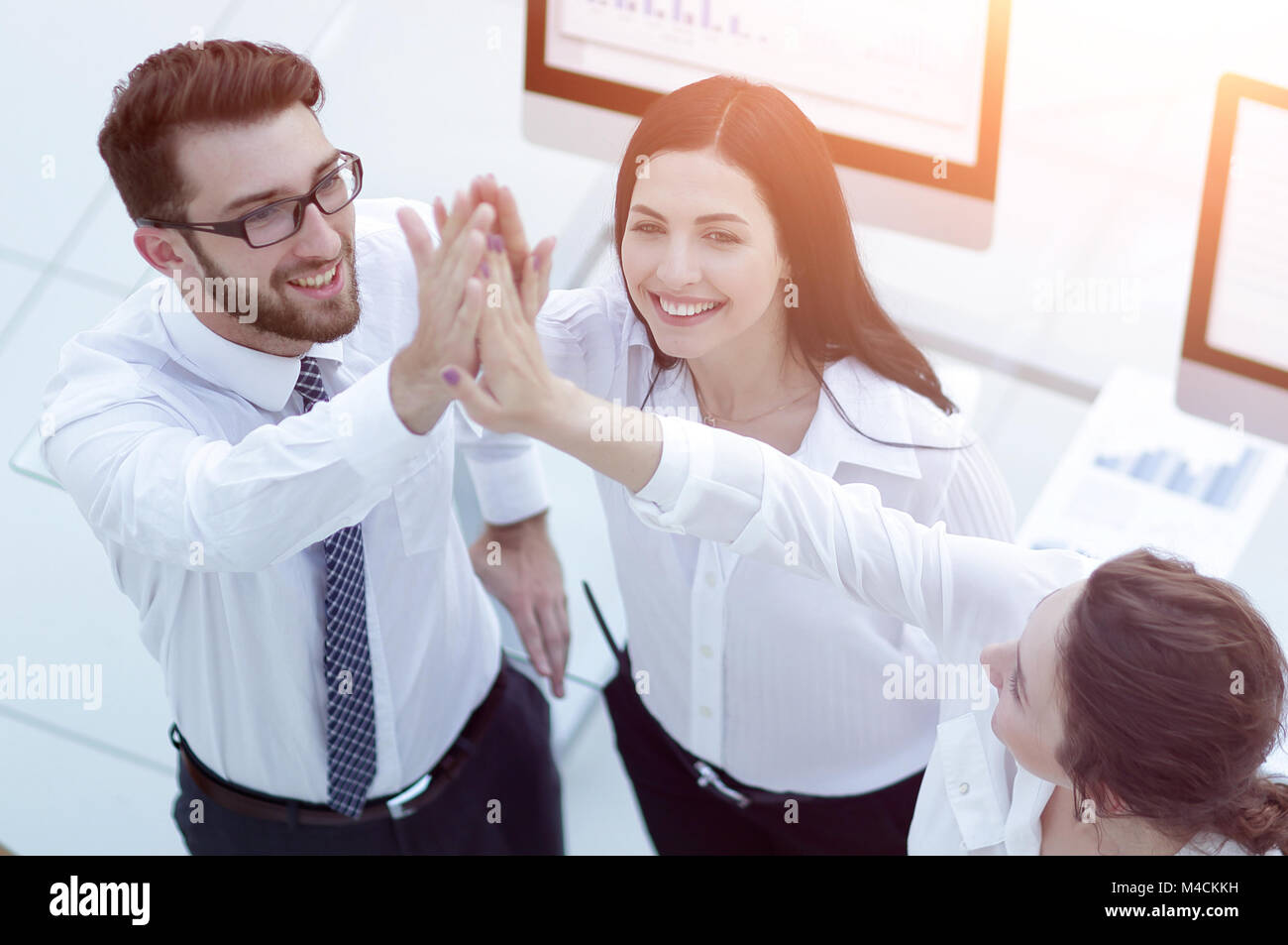 successful business team giving each other a high five Stock Photo - Alamy