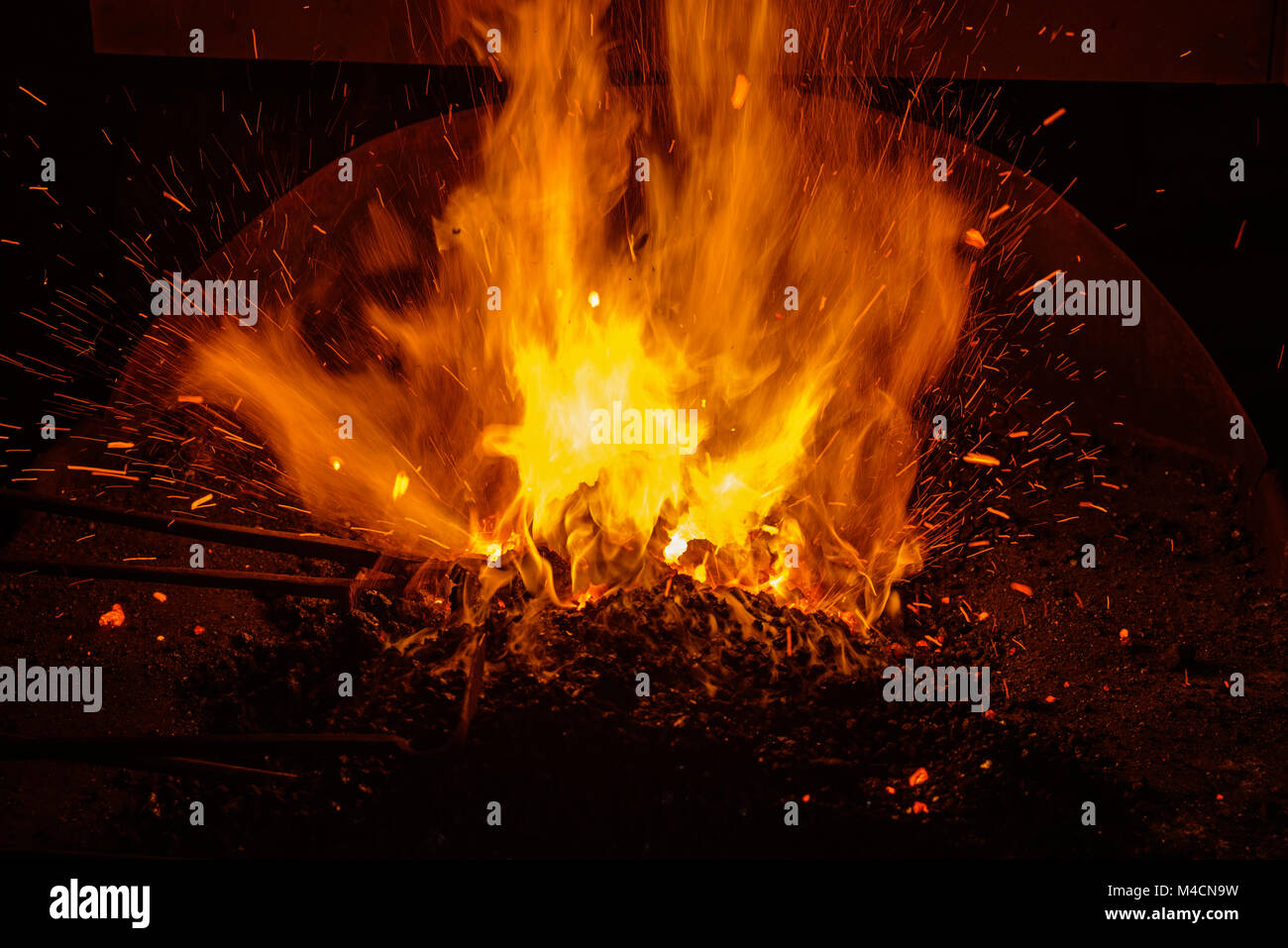 hot blacksmith forge with burning coals and sparks Stock Photo