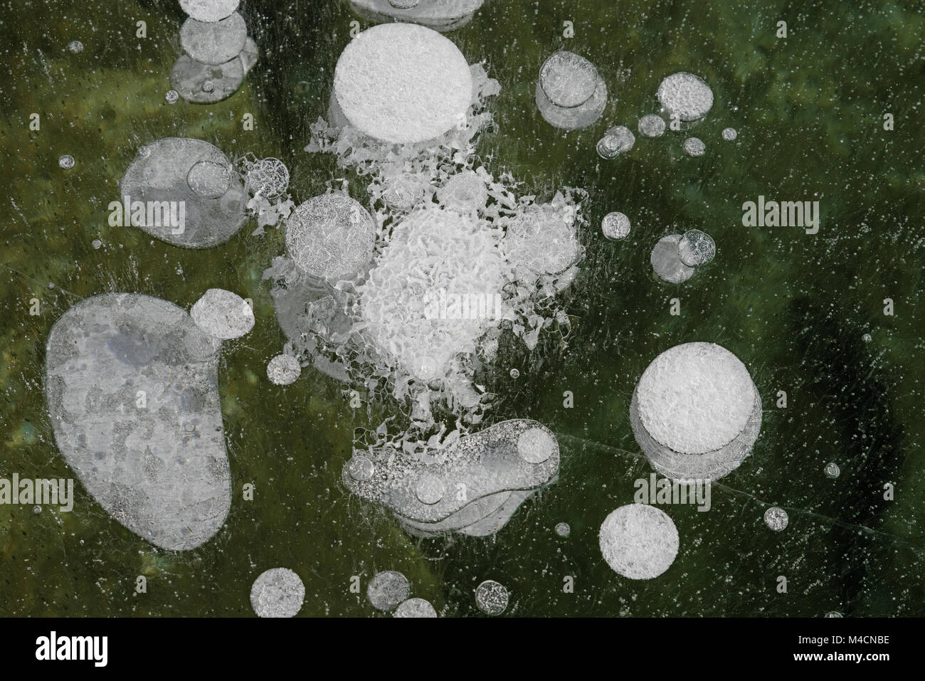 bubbles and crystals in the ice of a frozen alpine lake Stock Photo - Alamy