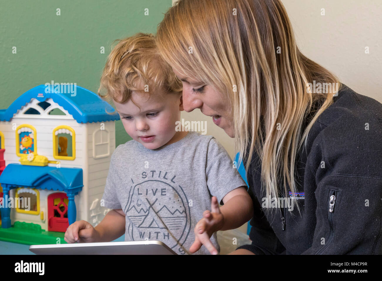 Denver, Colorado - A speech therapist works with a three year old boy. Stock Photo