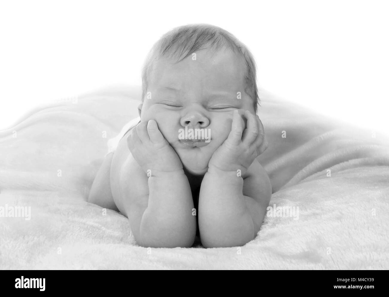 Newborn baby girl sleeping in nursery, beautiful new baby relaxed and