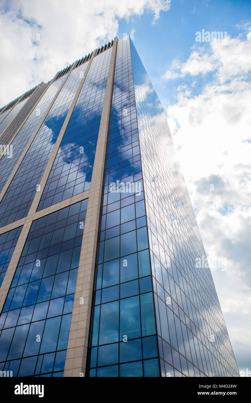Modern smoked glass office building against a blue cloudy sky Stock ...