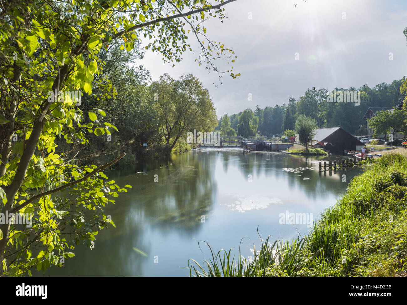 Long-term exposure of the sluice on the main river. Stock Photo