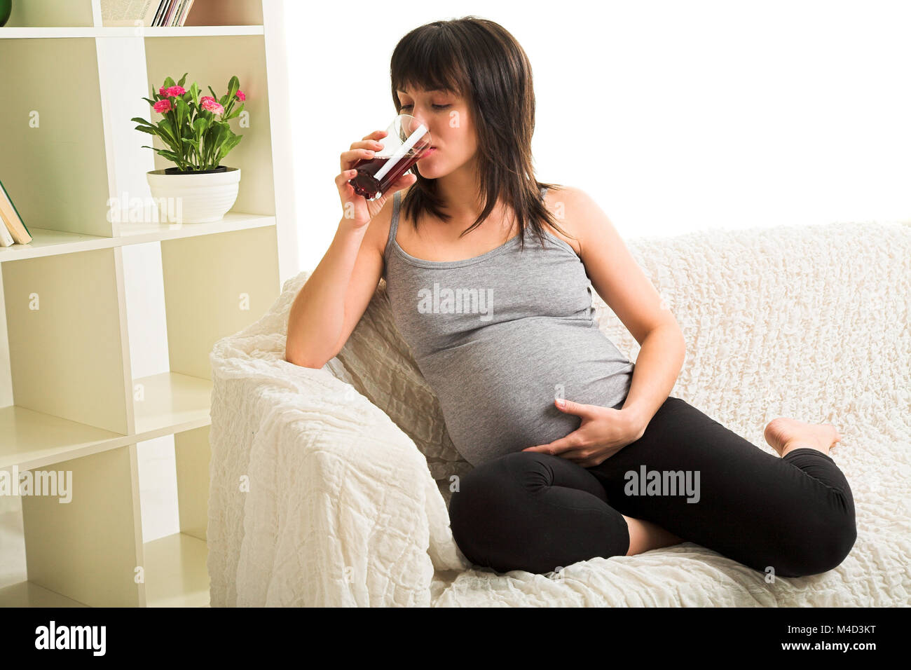 pregnant woman drinks a juice Stock Photo Alamy