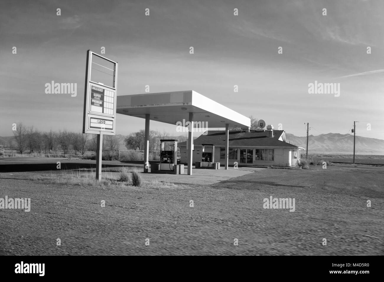 A closed, dilapidated gas station in the Utah desert in black and white. Stock Photo