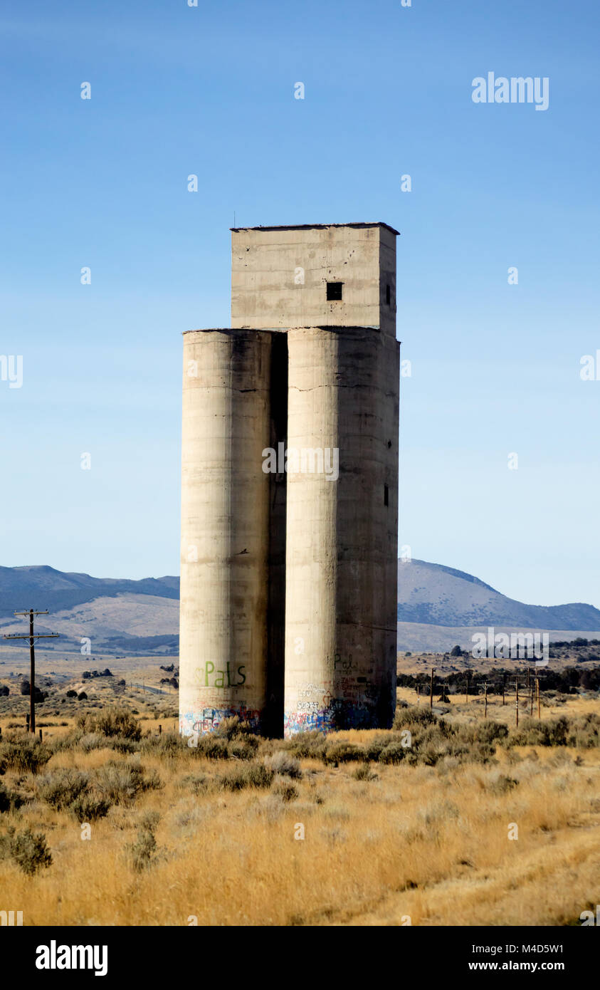 Concrete silos in the Utah desert plain on a bright blue sky Stock