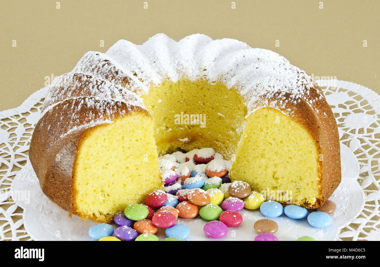 ring-shaped sponge cake and colour-varied sugar-coated chocolate confectionery Stock Photo