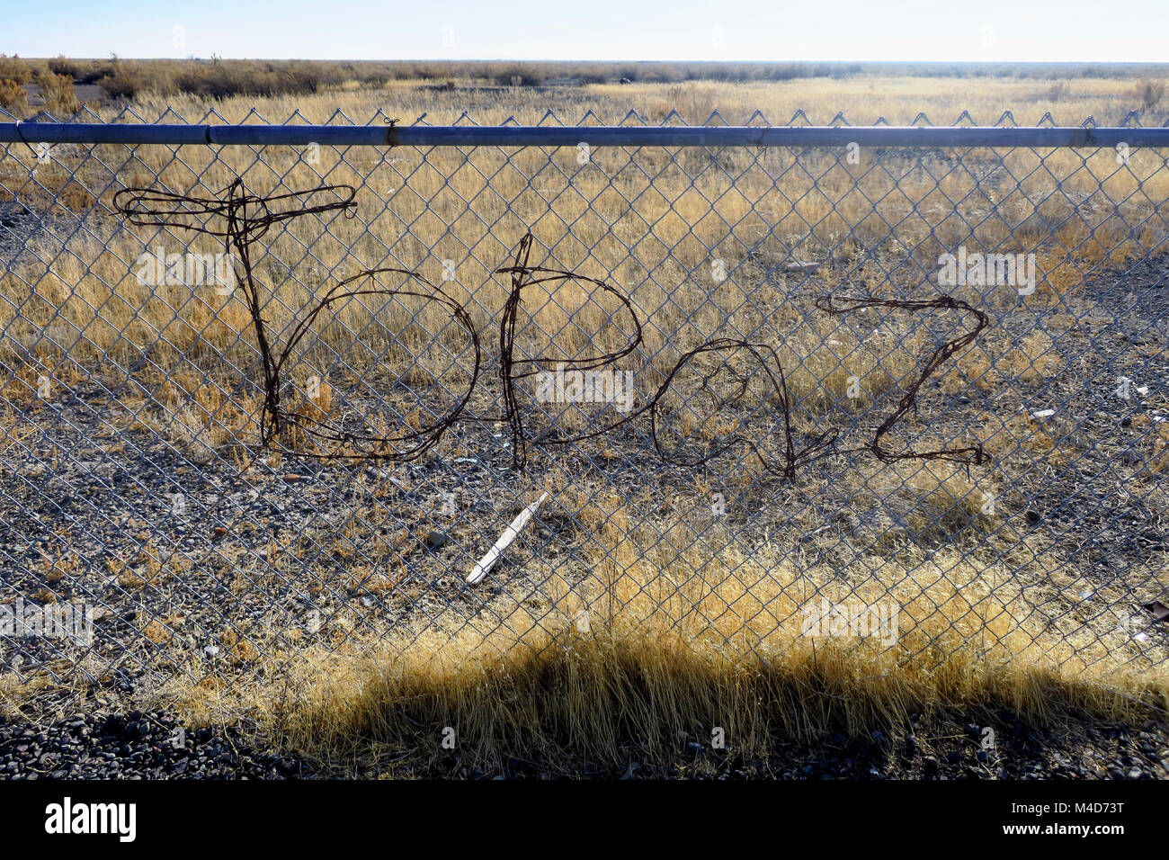 Topaz interment camp illustrated by wire on a fence near a monument in Central Utah. Stock Photo