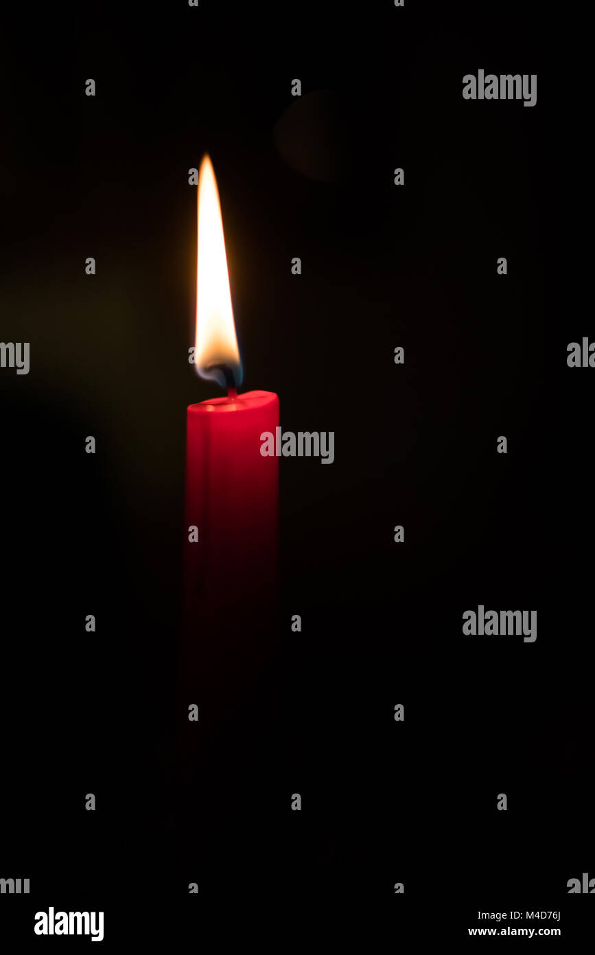Single burning candle in the dark Stock Photo Alamy
