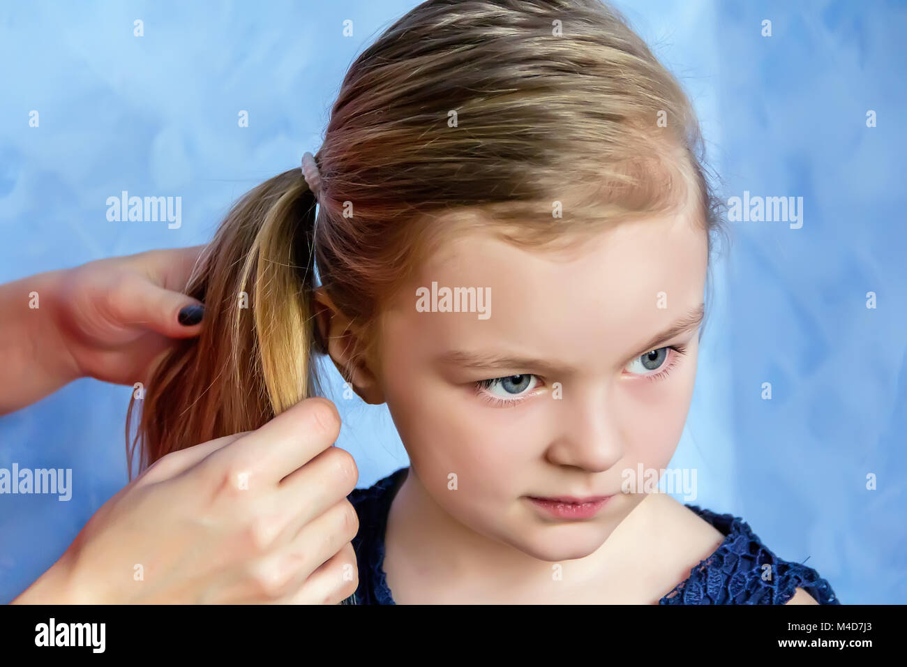 Mother and daughter makes hairstyle Stock Photo
