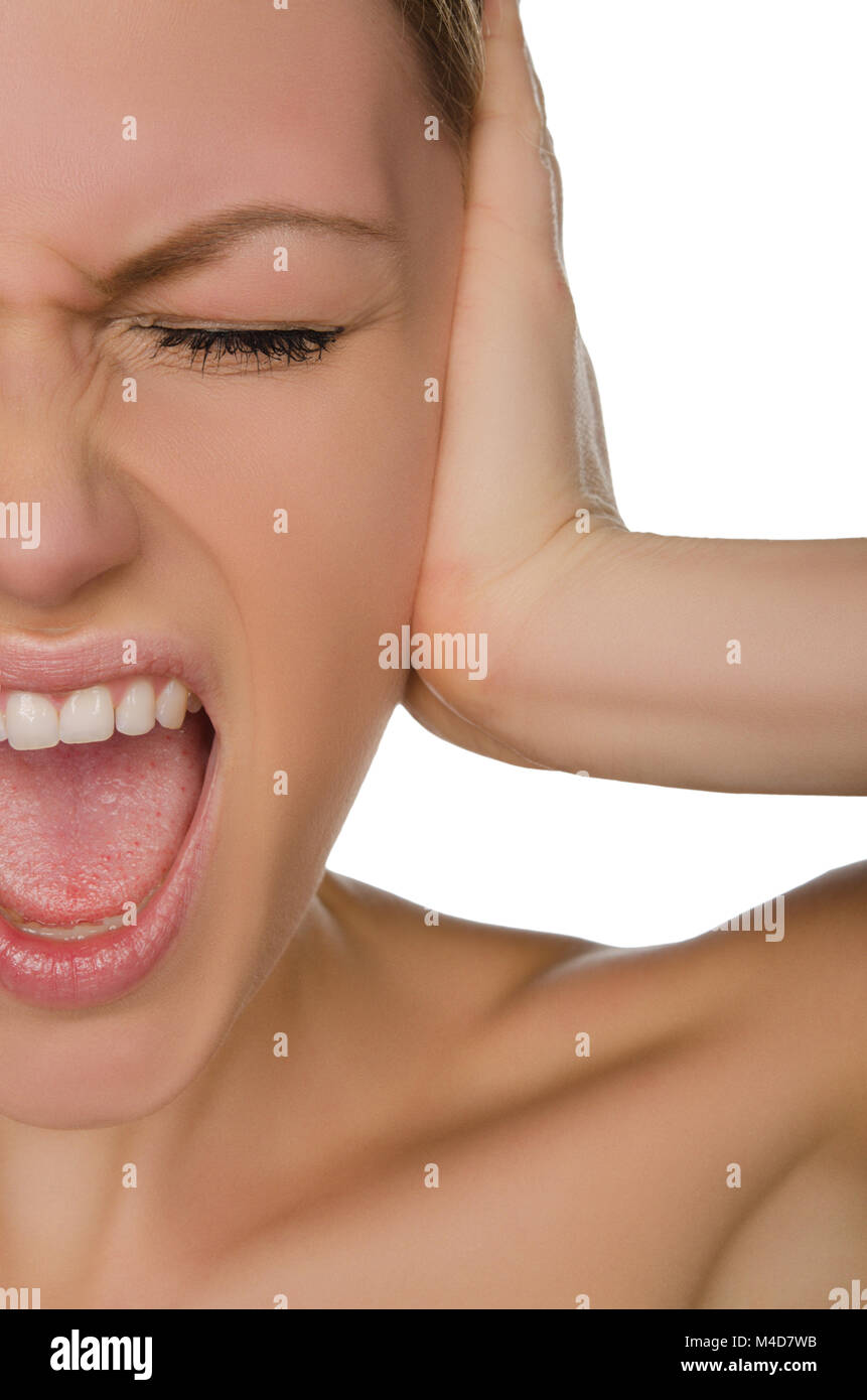 Emotional beautiful woman covers her ear with her palm Stock Photo