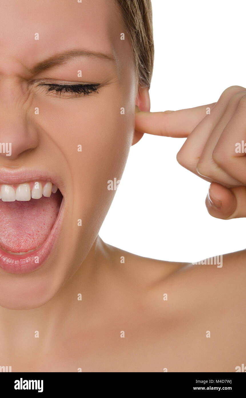 Emotional beautiful woman covers ear with her finger Stock Photo