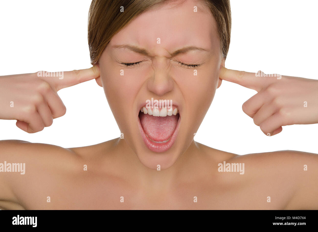 Beautiful emotional woman covers her ears with fingers Stock Photo